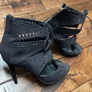 4 in black heel with tie in the front and gold zippers on the back